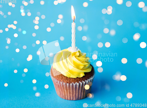 Image of birthday cupcake with one burning candle