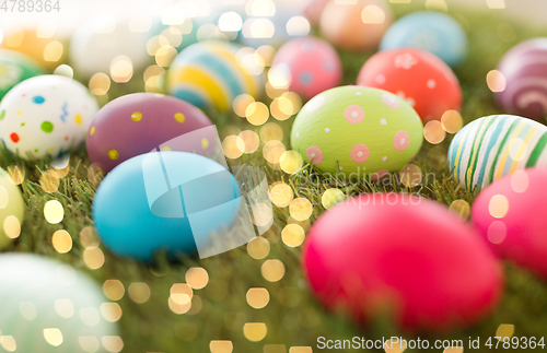 Image of colored easter eggs on artificial grass