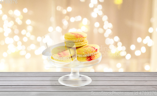 Image of yellow macaroons on glass confectionery stand