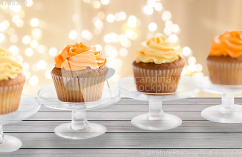 Image of cupcakes with frosting on confectionery stands