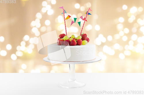 Image of close up of birthday cake with garland on stand