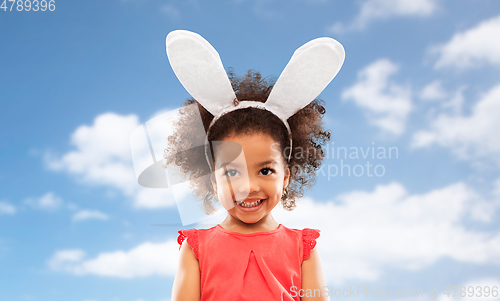 Image of happy little girl wearing easter bunny ears