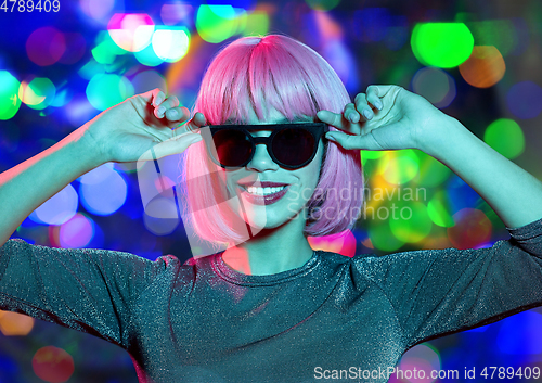 Image of happy woman in pink wig and black sunglasses