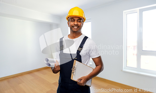 Image of happy indian builder with blueprint and clipboard