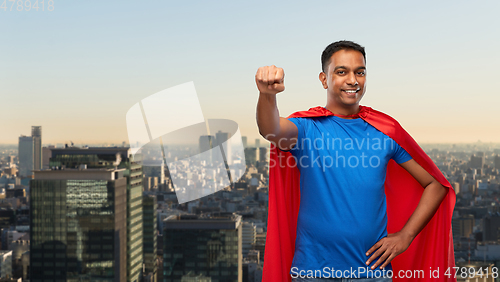 Image of indian man in superhero cape makes winning gesture
