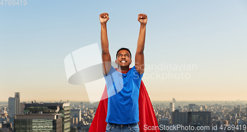 Image of indian man in superhero cape fluing in tokyo city