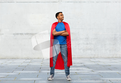 Image of happy smiling indian man in red superhero cape
