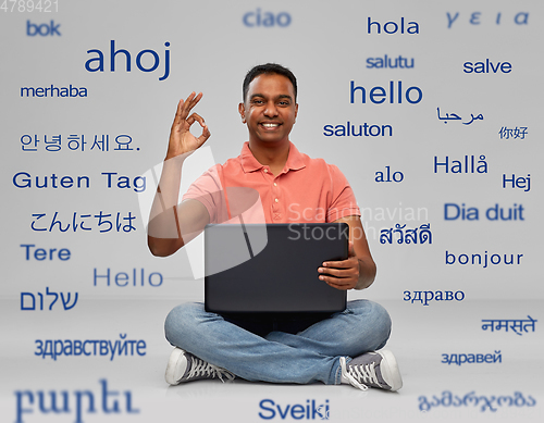 Image of happy indian man with laptop computer showing ok