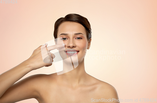 Image of beautiful smiling woman showing her nose