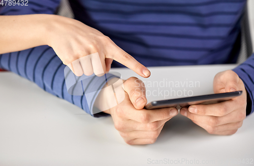 Image of close up of hands with tablet computer