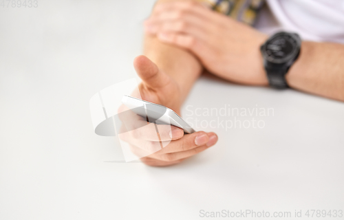 Image of close up of male hands with smartphone