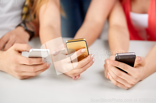 Image of close up of hands with smartphones