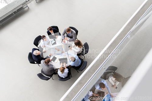 Image of architects with blueprint and report at office