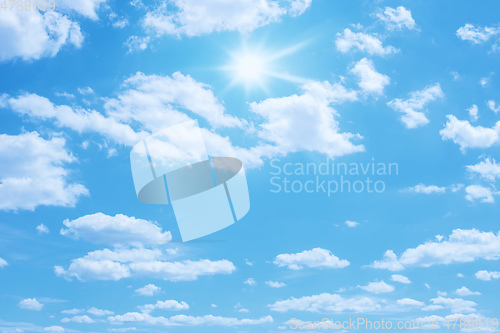 Image of blue sky with sun and clouds background