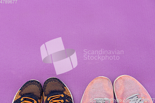 Image of Sneakers and purple fitness mat. Sport concept