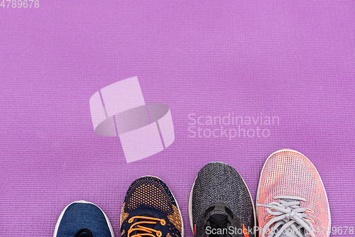 Image of Sneakers and purple fitness mat. Sport concept