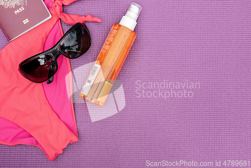 Image of Top view of summer accessories on purple background