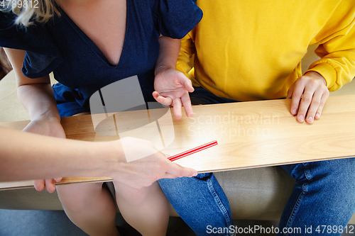 Image of Interior designer working with young couple. Lovely family and professional designer or architector.