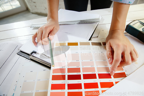 Image of Interior designer working with colour palette in modern office