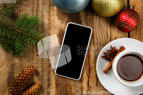 Image of Mock up blank empty screen of smartphone on wooden background