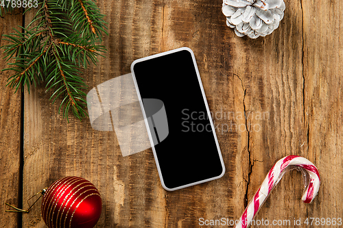 Image of Mock up blank empty screen of smartphone on wooden background