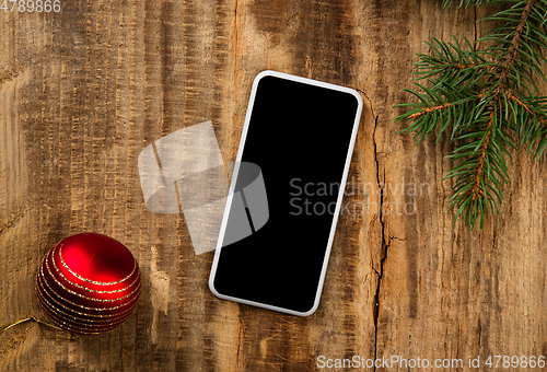 Image of Mock up blank empty screen of smartphone on wooden background