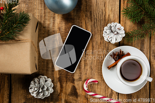 Image of Mock up blank empty screen of smartphone on wooden background