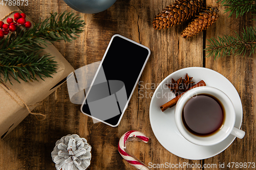 Image of Mock up blank empty screen of smartphone on wooden background