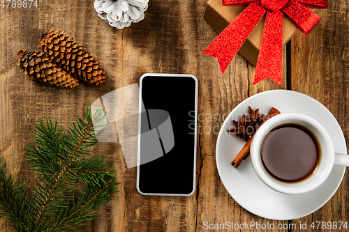 Image of Mock up blank empty screen of smartphone on wooden background