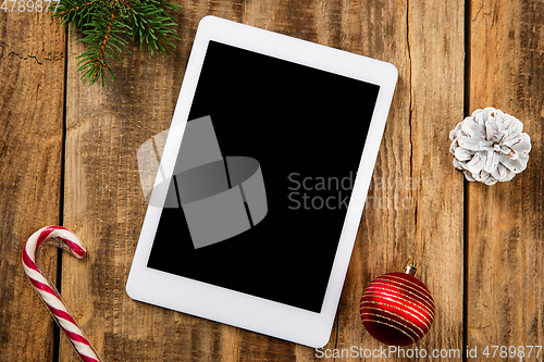 Image of Mock up blank empty screen of tablet on wooden background