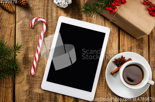 Image of Mock up blank empty screen of tablet on wooden background