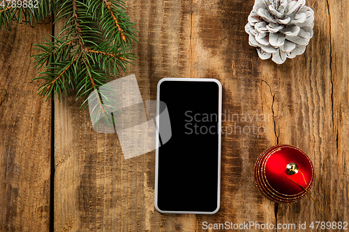 Image of Mock up blank empty screen of smartphone on wooden background