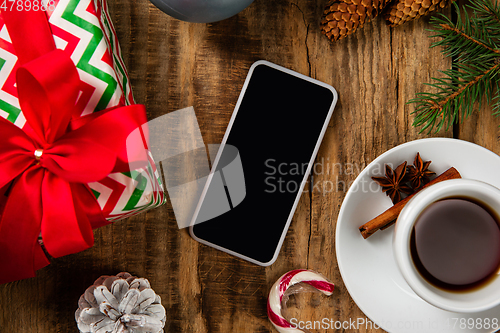 Image of Mock up blank empty screen of smartphone on wooden background