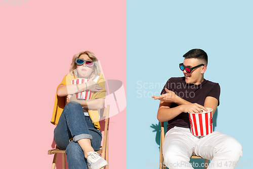 Image of Young emotional man and woman on pink and blue background