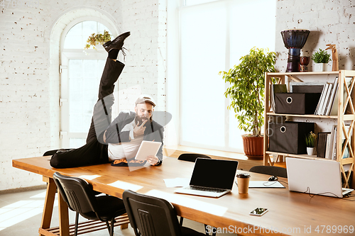 Image of Businessman having fun dancing break dance in the office at work