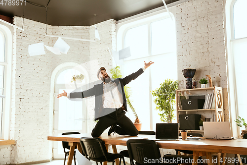 Image of Businessman having fun dancing break dance in the office at work