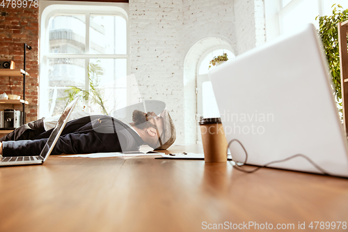 Image of Businessman having fun dancing break dance in the office at work