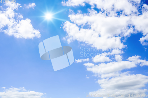Image of blue sky with sun and clouds background