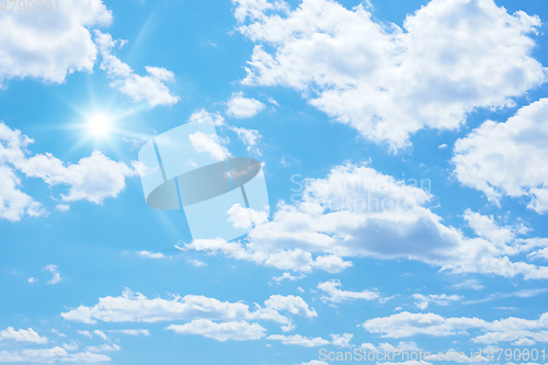 Image of blue sky with sun and clouds background