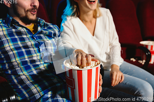 Image of Attractive young caucasian couple watching a film at a movie theater