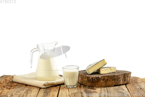 Image of Different milk products, cheese, cream, milk on wooden table and white background.