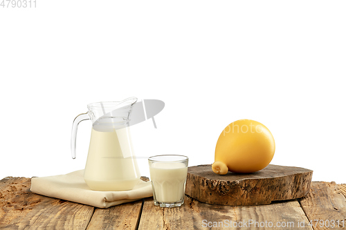 Image of Different milk products, cheese, cream, milk on wooden table and white background.