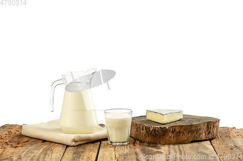 Image of Different milk products, cheese, cream, milk on wooden table and white background.