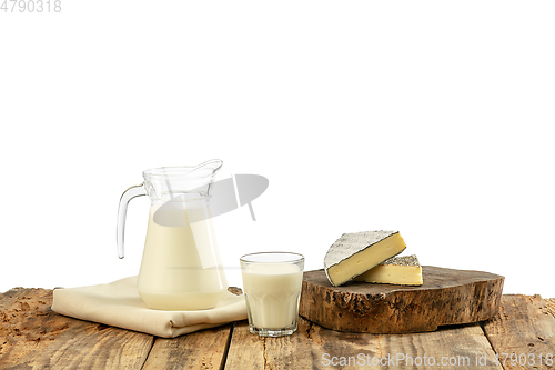 Image of Different milk products, cheese, cream, milk on wooden table and white background.