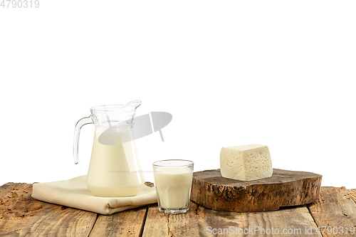 Image of Different milk products, cheese, cream, milk on wooden table and white background.