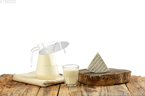 Image of Different milk products, cheese, cream, milk on wooden table and white background.