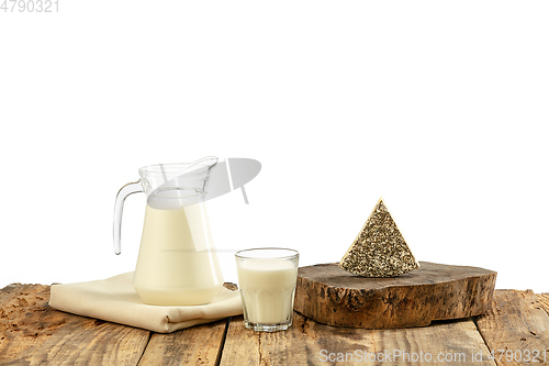 Image of Different milk products, cheese, cream, milk on wooden table and white background.