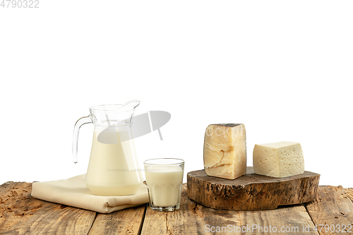 Image of Different milk products, cheese, cream, milk on wooden table and white background.