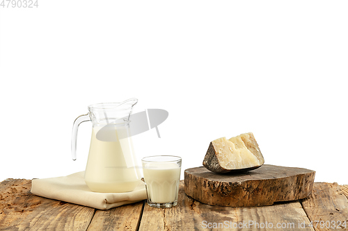 Image of Different milk products, cheese, cream, milk on wooden table and white background.