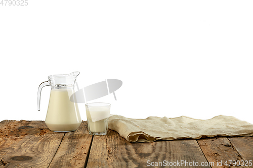 Image of Different milk products, cheese, cream, milk on wooden table and white background.